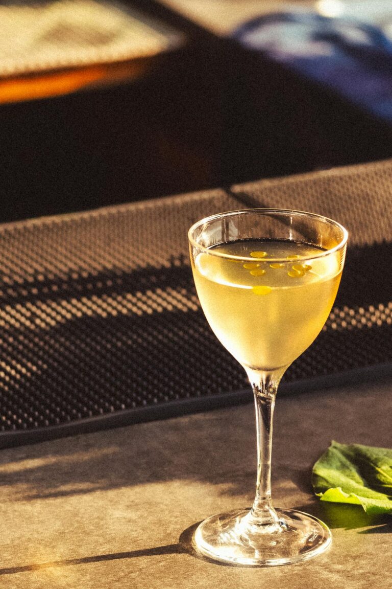 A refreshing mezcal cocktail served in a stylish glass at a bar in Oaxaca, Mexico.